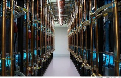 A view inside a mining farm showcasing rows of mining rigs and cooling systems.