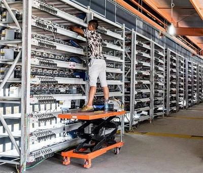 A mining farm with rows of mining rigs and a focus on cooling systems